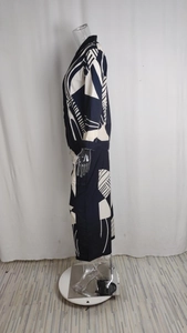 Detail of navy blue two-piece set featuring oversized geometric print and buttoned shirt