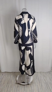 Detail view of the back of a black and white geometric print shirt and pants set