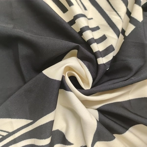 Macro detail of high-contrast black and white geometric print fabric with soft drape