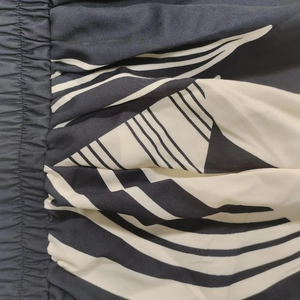 Detail of high-waisted elastic waistband with black and white abstract zebra print fabric