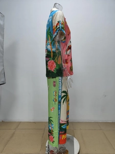 Detail of vintage tropical floral print on button-up shirt and trouser coordinates