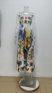 Detailed close-up of white summer dress with colorful artistic sun and heart patterns