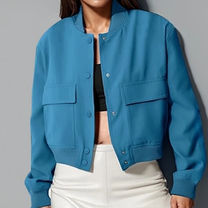 Detalle de chaqueta corta azul con bolsillos de solapa frontales y cuello de punto acanalado