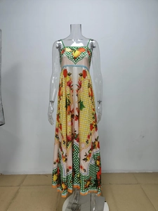 Detail of vibrant lemon and orange fruit print on elegant high waist maxi dress fabric
