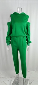 Detail of green women's two-piece set featuring off-shoulder hoodie and tapered sweatpants