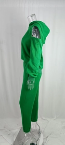 Detail view of emerald green hooded tracksuit with off-shoulder design and elastic waist