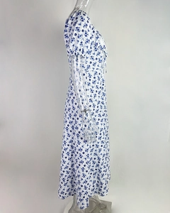 Detail of blue and white floral dress featuring puff sleeves and a delicate neckline tie