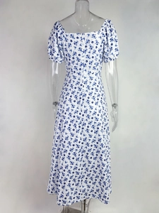 Detail view of the back zipper and blue floral print on this white summer dress