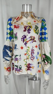 Detailed view of puff sleeves and mystical print on elegant women's button-down shirt