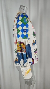 Detail of printed puff sleeves with white decorative buttons on a patterned shirt