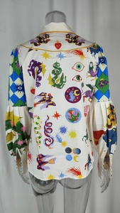 Detail of satin shirt back with mystic eye and snake graffiti print and lantern sleeves