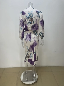Detail of elegant V-neck dress with purple and cyan abstract watercolor floral print