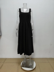 Detailed close-up of a black square-neck sleeveless midi dress with elegant A-line cut