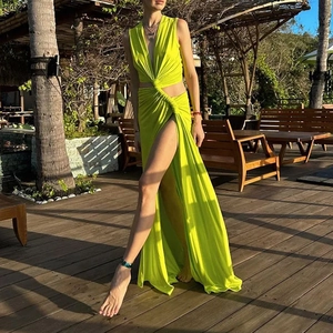 Detail of neon green cutout maxi dress featuring a high side slit and plunging V-neckline