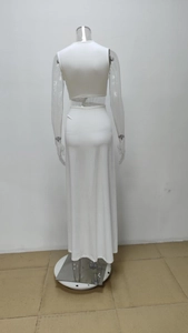 Detail showing the white backless sleeveless top and long skirt two-piece set
