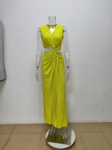 Detail of neon green knit dress showing waist cut-out and knotted draped fabric texture