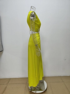 Detail of waist cut-out and draped pleats on bright yellow sleeveless maxi dress