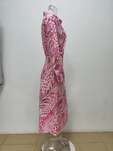 Seitenansicht eines eleganten Kleides mit rosa-weißem Blattmuster, Langarm und Taillengürtel
