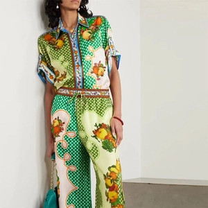 Detail of vibrant fruit print on silky fabric with blue trim and elastic waistband