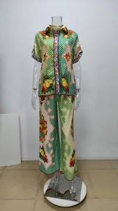 Detail of two-piece floral satin set featuring green polka dots and fruit patterns
