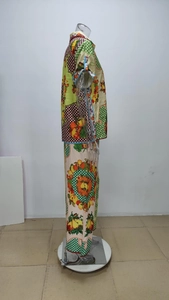 Detail of vibrant fruit and geometric print on lightweight shirt and wide-leg trousers set