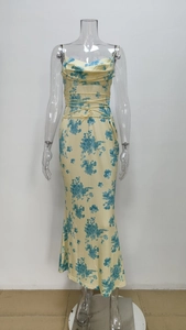Detail of floral print dress featuring adjustable waist drawstring and pleated neckline
