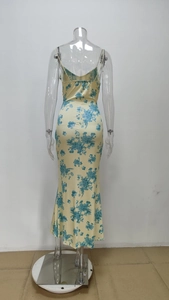 Detail of floral print satin maxi dress featuring a low back design and mermaid hem