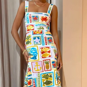 Detail of scalloped lace straps and vibrant marine print on a white summer sundress