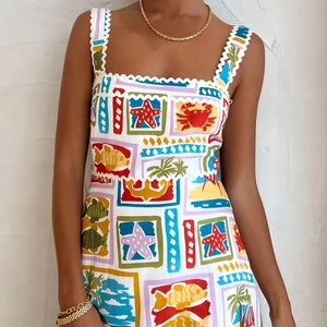 Detail of colorful marine print dress with wavy straps and vibrant sea life patterns