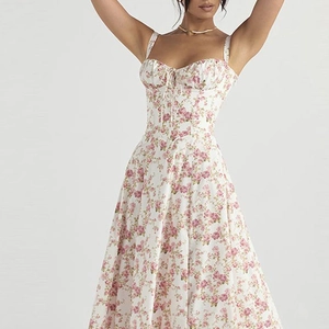 Detail of vintage floral corset dress with pink rose print and delicate tie-up bodice
