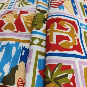 Detail of vibrant nautical graffiti print fabric with fish and anchor patterns