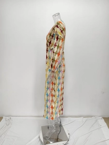Close-up of pleated maxi dress featuring colorful geometric diamond print fabric