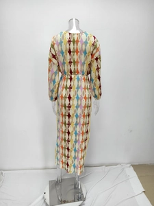 Detail view of colorful geometric pleat dress showing back texture and vibrant pattern