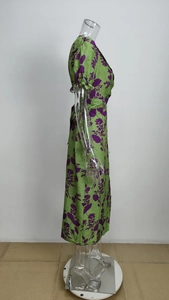 Detail of green floral midi dress showing puff sleeves and elastic ruffled cuffs