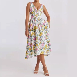 Detailed macro view of the colorful pink and yellow rose floral print on a white midi dress