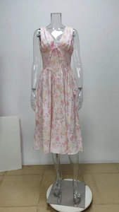 Detail of pink floral dress featuring a deep V-neckline and adjustable drawstring waist