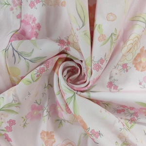 Close-up of lightweight floral fabric showing soft pink floral patterns and delicate texture