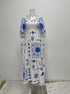 Detail of French vintage white dress featuring blue sun prints and le Soleil lettering