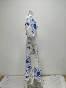 Detail of puff sleeves and French sun print on a white floral long dress