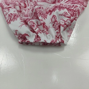 Détail de l'imprimé toile de jouy rouge avec poignet élastiqué sur robe vintage