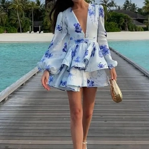Elegant V-neck ruffle dress with blue floral print and lantern sleeves for beach vacation