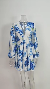Detail of V-neck puff sleeve dress with elegant blue hydrangea floral print on white