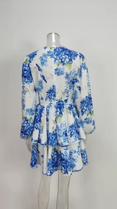 Detail view of the back of the floral dress showing double layered ruffles and zipper