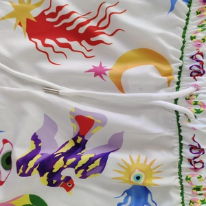 Detail of drawstring waist with colorful graffiti patterns and pop art moon star prints