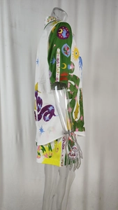 Detail of surrealist pattern print on a lightweight short sleeve shirt and shorts set