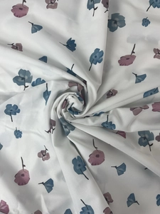 Detailed view of floral fabric featuring blue and purple patterns on a white base