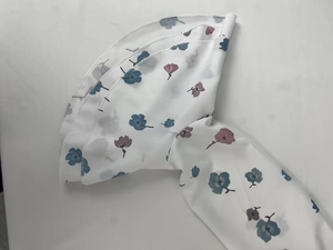 Close-up of floral print chiffon dress with triple-layered ruffle sleeves and blue flowers