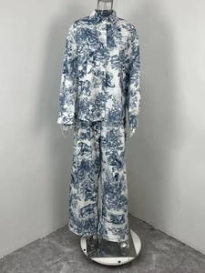 Detail of blue Toile de Jouy print featuring jungle animals on woven shirt and pants set