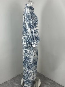 Detail of blue tiger jungle print on white long-sleeve pajama shirt and trousers set