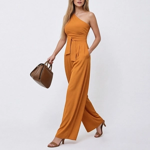 Detail of one-shoulder jumpsuit featuring a belted waist and functional side pockets
